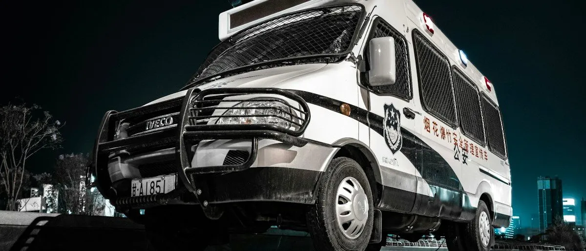 Un chauffeur de taxi parisien aidant un patient à monter dans son véhicule devant un hôpital